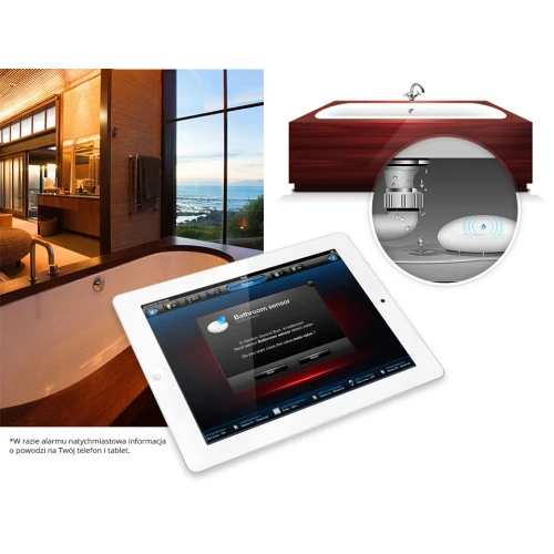 Na zdjęciu znajduje się czujnik zalania wodą Fibaro, przedstawiony w kontekście łazienki z wanną. Obok czujnika widoczny jest tablet z aplikacją do monitorowania stanu czujnika.