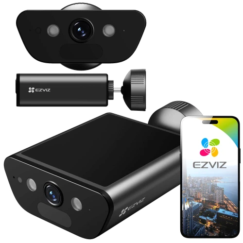 Na zdjęciu znajduje się czarna kamera smart home 4K marki EZVIZ, pokazana z różnych perspektyw. Obok kamery widoczny jest smartfon z aplikacją EZVIZ na ekranie, prezentującą widok miasta.