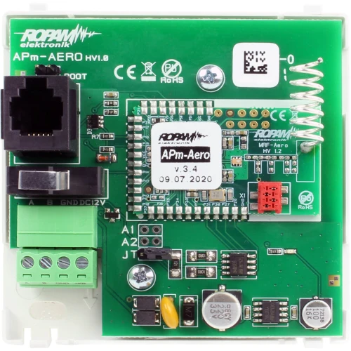 Zdjęcie przedstawia kontroler Ropam APm-Aero z widocznymi komponentami elektronicznymi na zielonej płytce drukowanej. Na płytce znajdują się złącza, moduły i oznaczenia techniczne, w tym logo producenta.