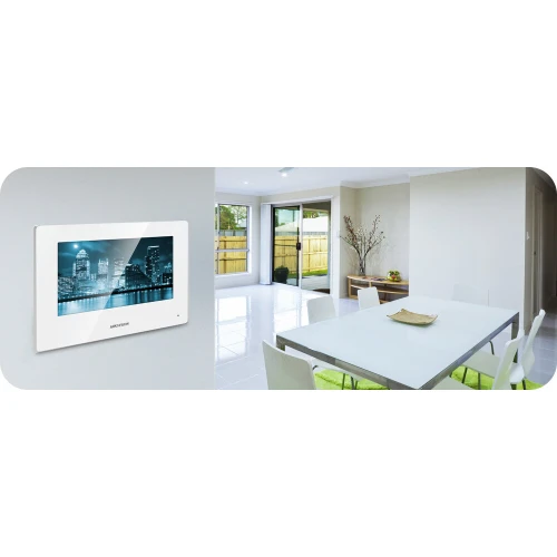 Na zdjęciu znajduje się nowoczesny wideodomofon z ekranem dotykowym zamontowany na ścianie w jasnym, minimalistycznym wnętrzu. Urządzenie wyświetla obraz z kamery, a jego elegancki design harmonizuje z wystrojem pomieszczenia.