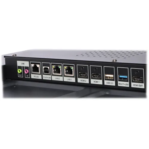 Zdjęcie przedstawia panel z różnymi złączami, w tym audio, RS 232, LAN, HDMI i USB. Złącza są oznaczone etykietami, a panel ma ciemny kolor z perforacją na górze.